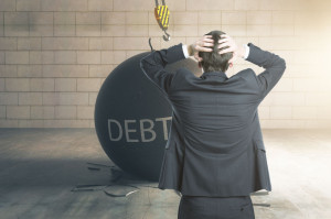 68725750 - debt concept. stressed businessman with wrecking ball