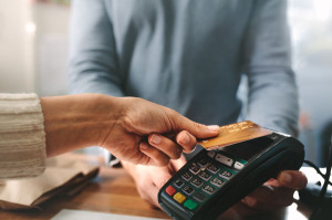 Pharmacist accepting credit card by contactless payment