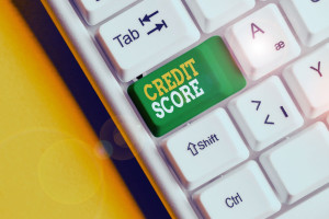 Conceptual hand writing showing Credit Score. Business photo text Represent the creditworthiness of an individual Lenders rating White pc keyboard with note paper above the white background.