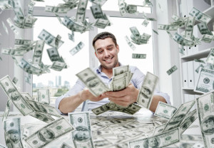 happy businessman with heap of money